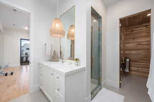 Bathroom featuring vanity, a stall shower, and recessed lighting