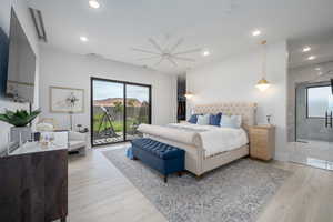 Bedroom featuring light wood finished floors, access to exterior, ceiling fan, recessed lighting, and a spacious closet