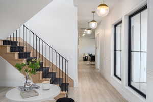Foyer entrance with light wood-type flooring and a decorative wall