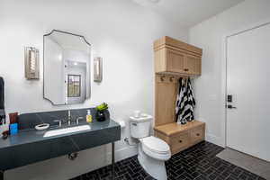 Bathroom with toilet and baseboards