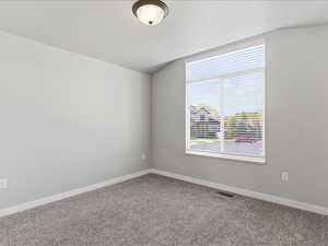 Unfurnished room featuring baseboards and carpet