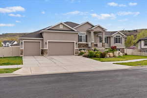 View of front of property with a gate, a garage, stucco siding, and concrete driveway