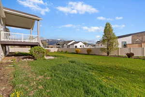 Fenced backyard with a residential view and a mountain view