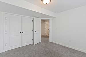 Unfurnished bedroom with carpet and a closet