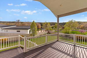 Wooden terrace with a fenced backyard and a residential view