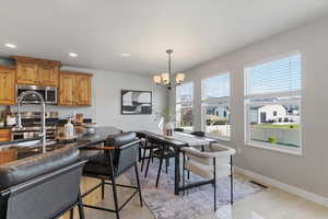 Dining room with a chandelier and baseboards
