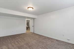 Unfurnished room featuring baseboards and carpet floors