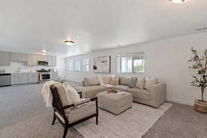 Living room with light carpet and baseboards