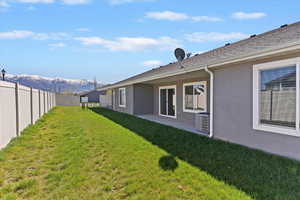 Fenced backyard featuring a patio and a mountain view