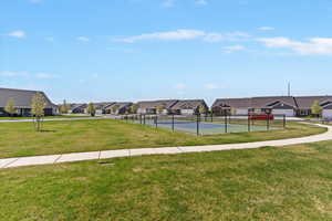 View of property's community with a tennis court and a residential view