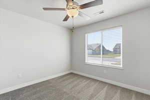 Unfurnished room with ceiling fan, a textured ceiling, and carpet floors
