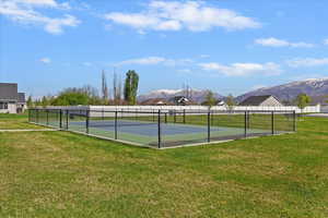 View of tennis court with a mountain view