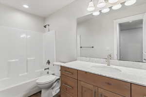 Full bath with vanity, bathing tub / shower combination, and recessed lighting