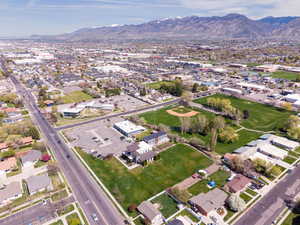 Aerial overview of property's location featuring a mountain backdrop and nearby suburban area
