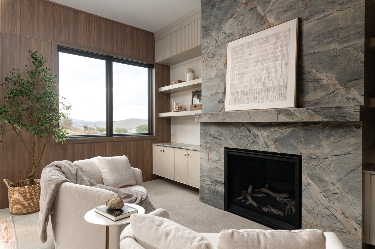 Living room featuring light colored carpet, a high end fireplace, and wooden walls