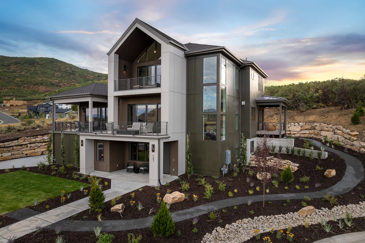 Back of property at dusk with a balcony