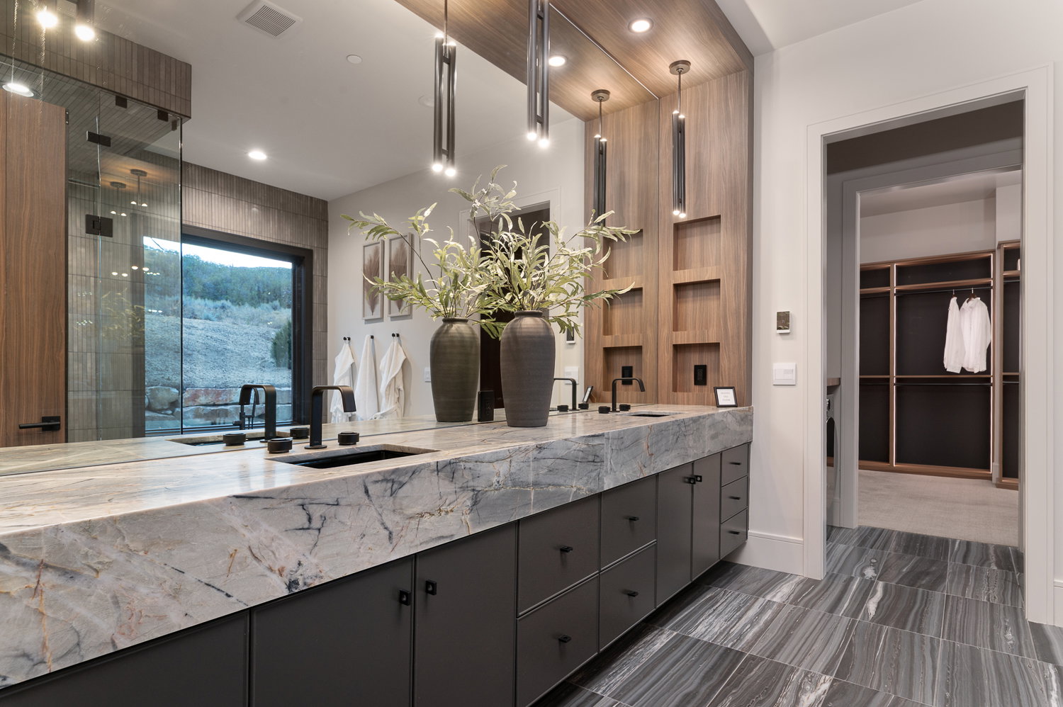 Full bath with double vanity, recessed lighting, a stall shower, and a walk in closet