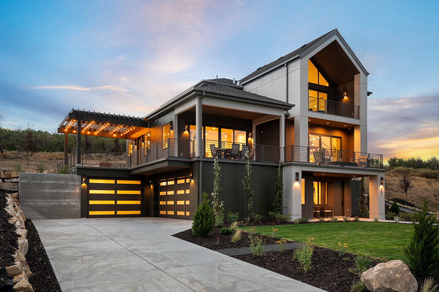 View of front of property featuring a front lawn, a garage, driveway, and board and batten siding