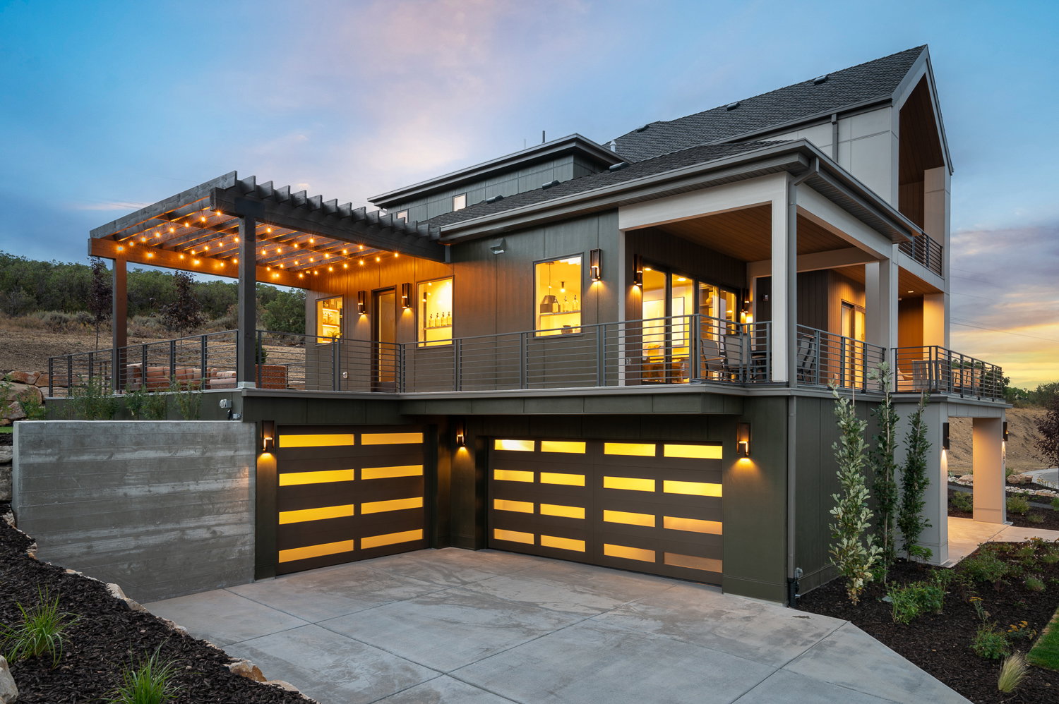 View of front of house with a shingled roof, an attached garage, and concrete driveway