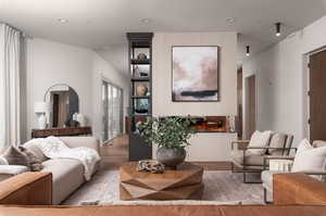 Living area with wood finished floors and recessed lighting