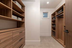 Walk in closet with light carpet