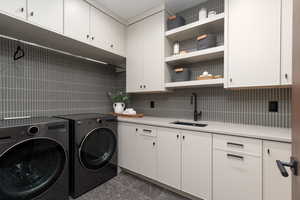 Laundry area featuring cabinet space and separate washer and dryer