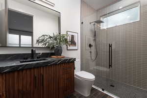 Full bathroom with vanity and a shower stall