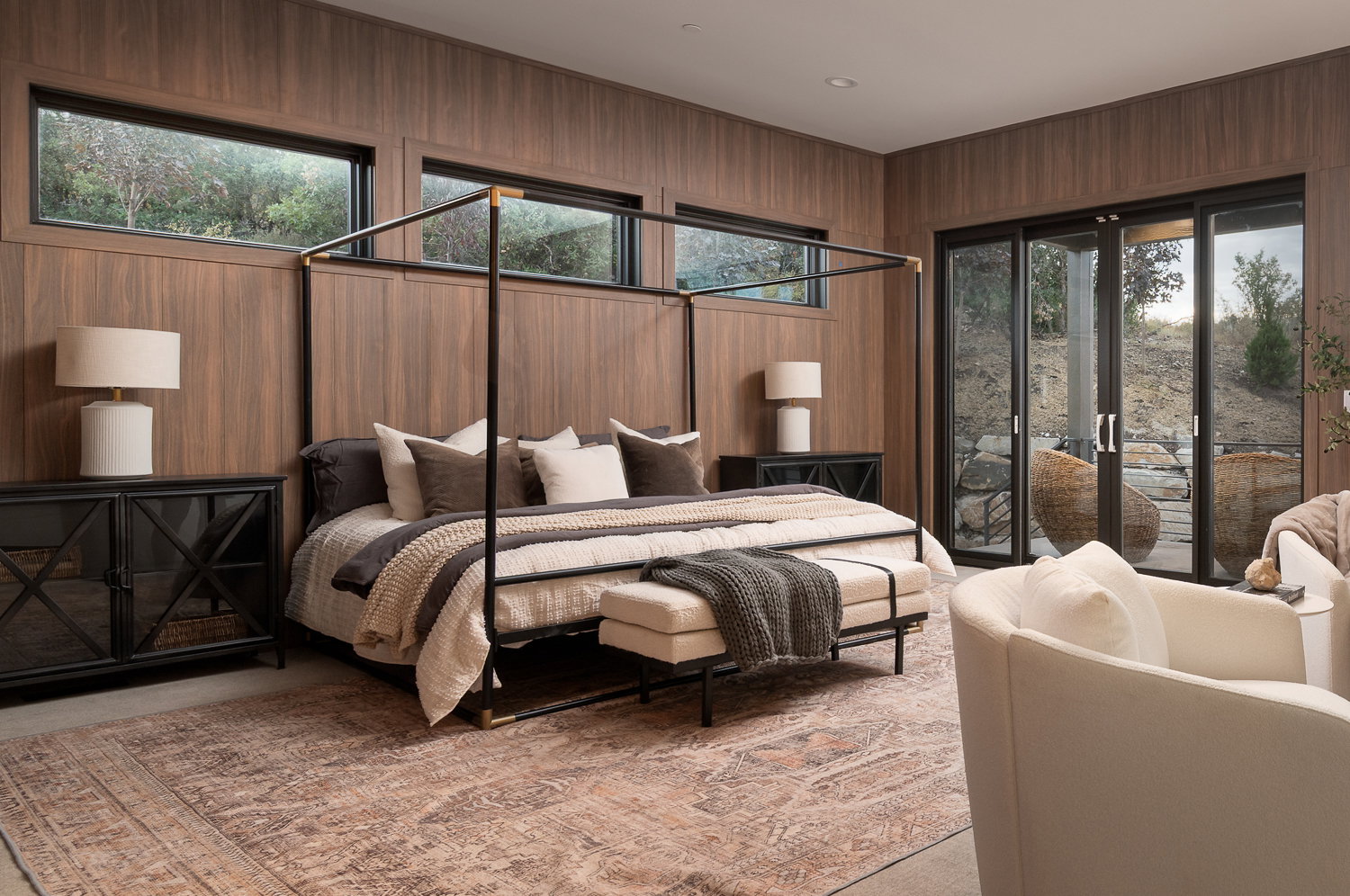 Bedroom with access to exterior and wooden walls