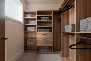 Walk in closet with light carpet