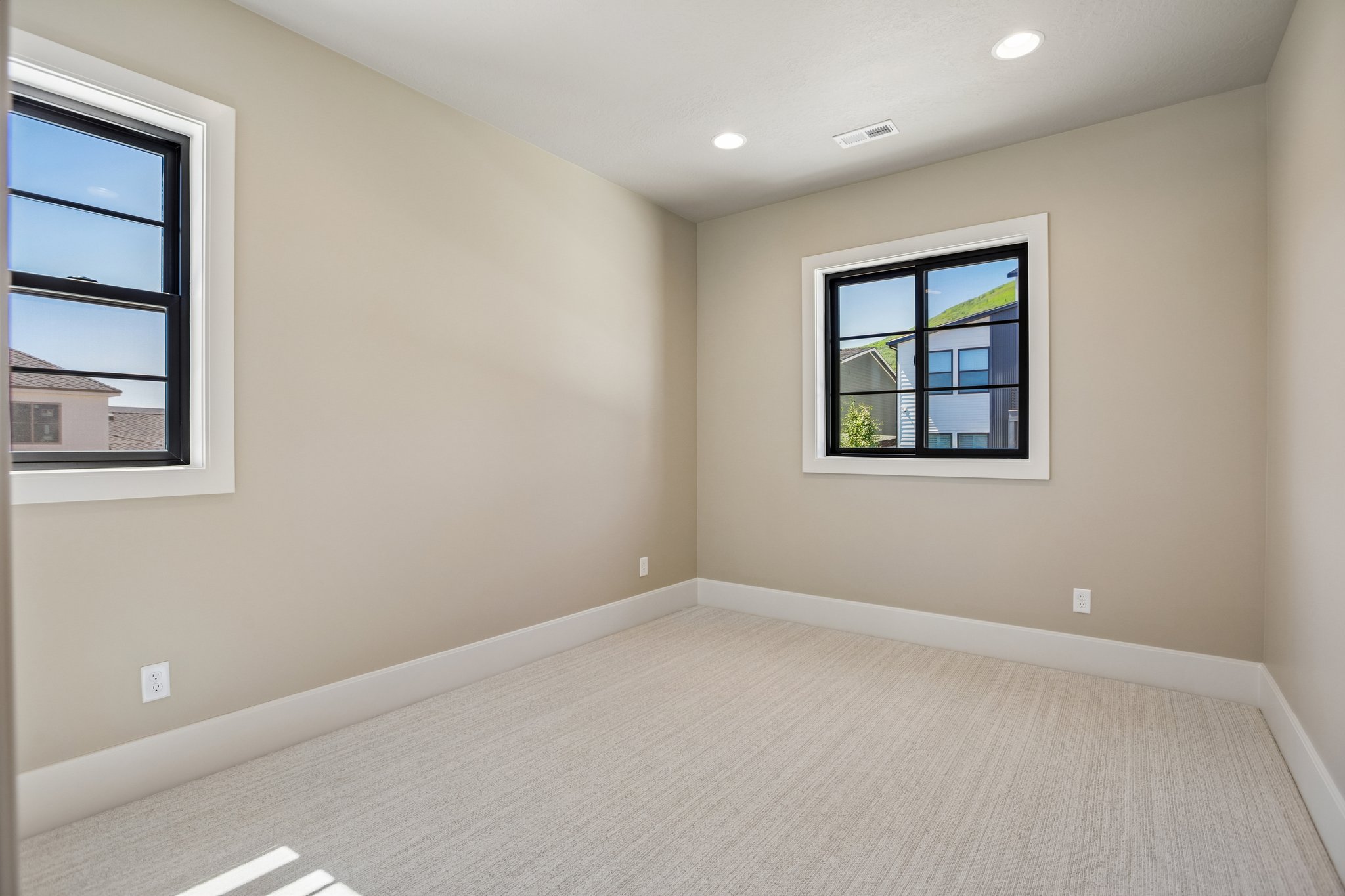 Neutral tone walls with white trim and light carpeting