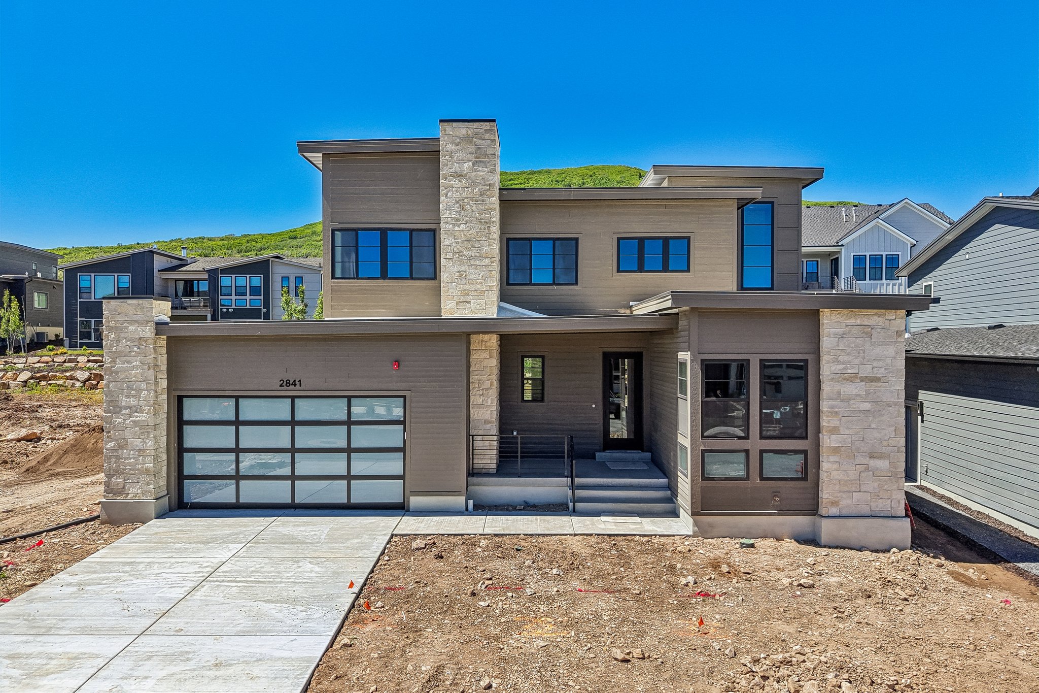Contemporary-style residence featuring a combination of horizontal siding and stacked stone accents