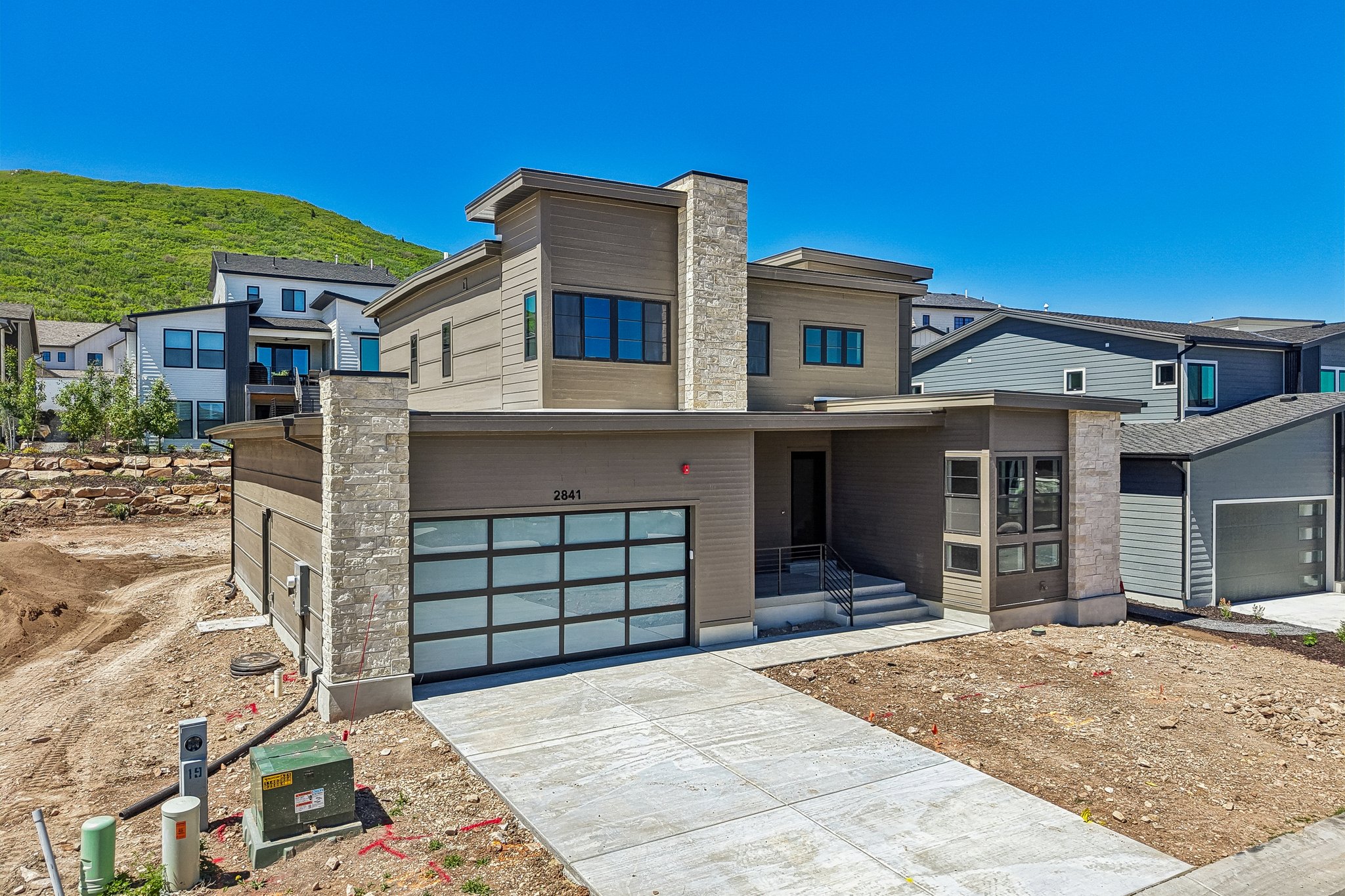 Modern exterior featuring stacked stone accents and horizontal siding