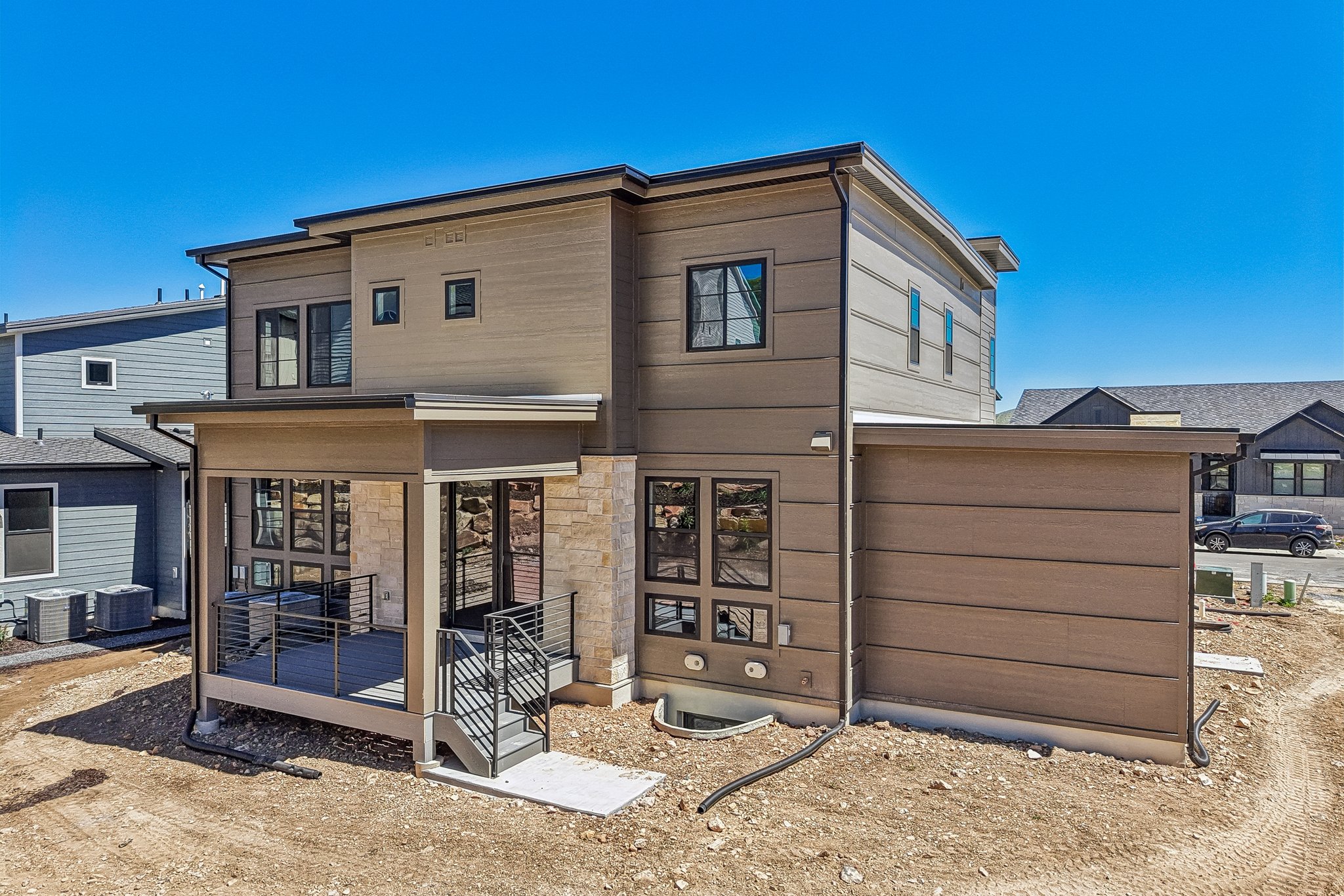 Modern exterior with horizontal siding and stone accents