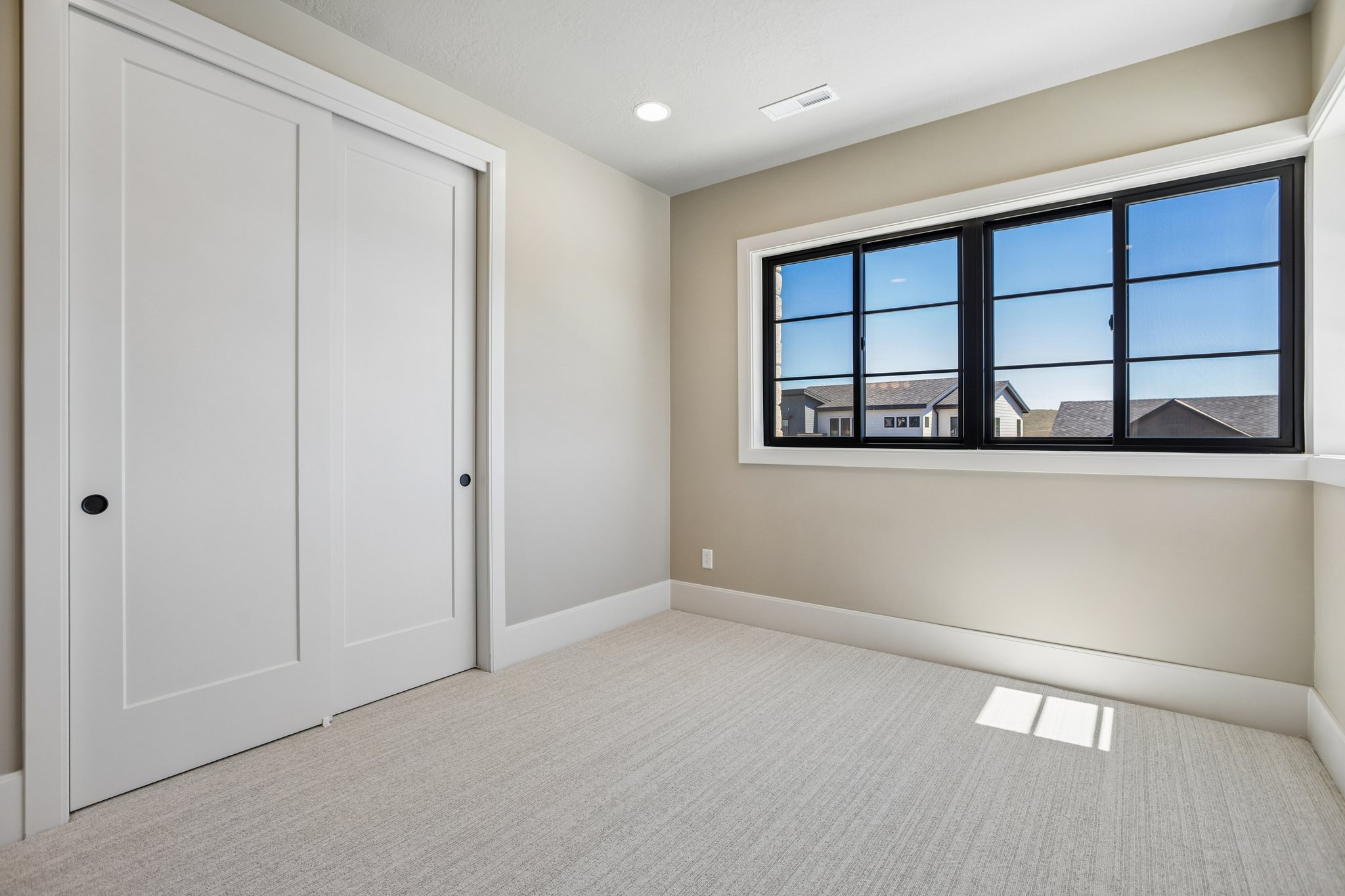 Room with light-toned carpet flooring and neutral wall paint