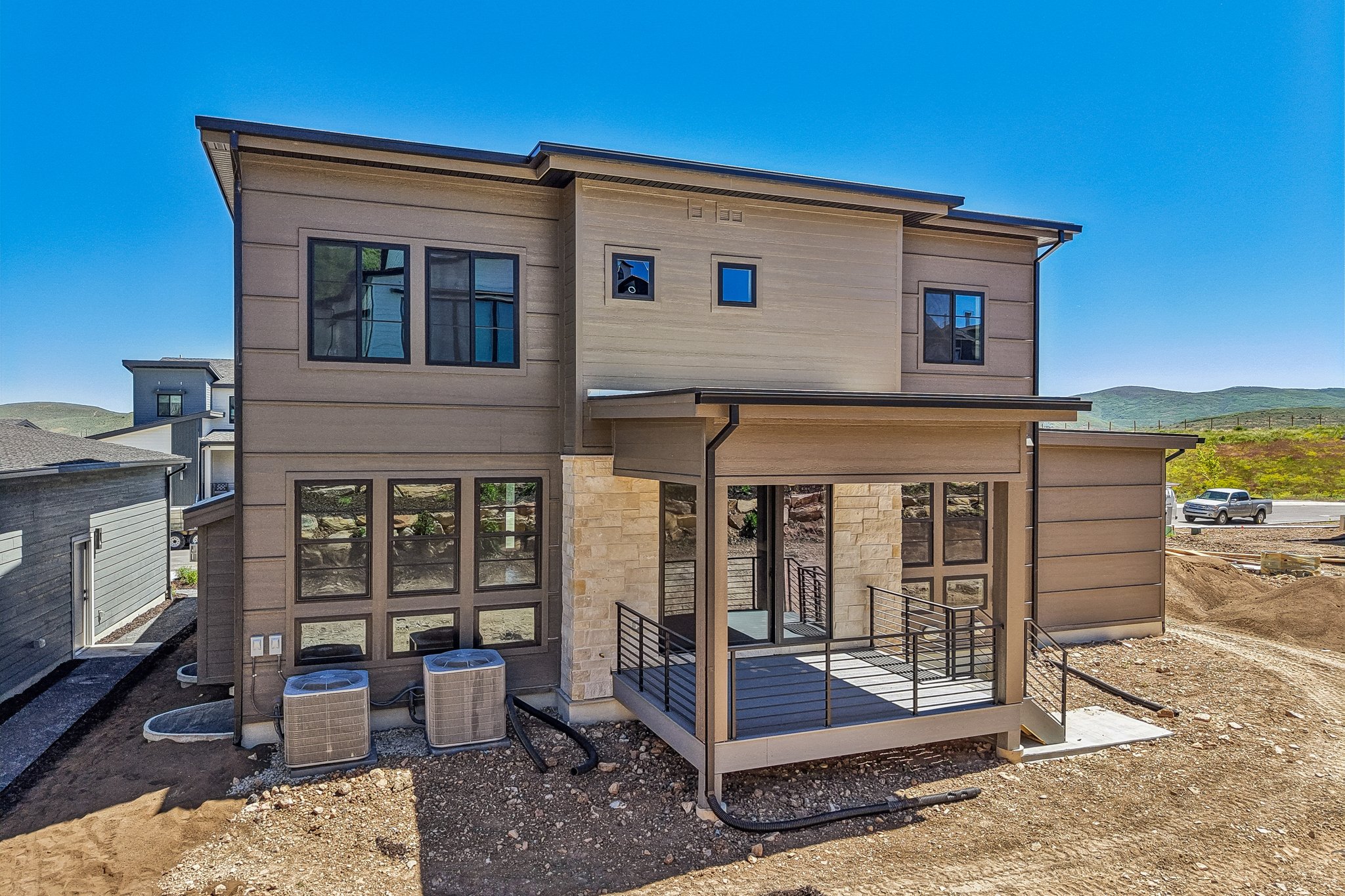 Contemporary exterior featuring horizontal siding and stone accents