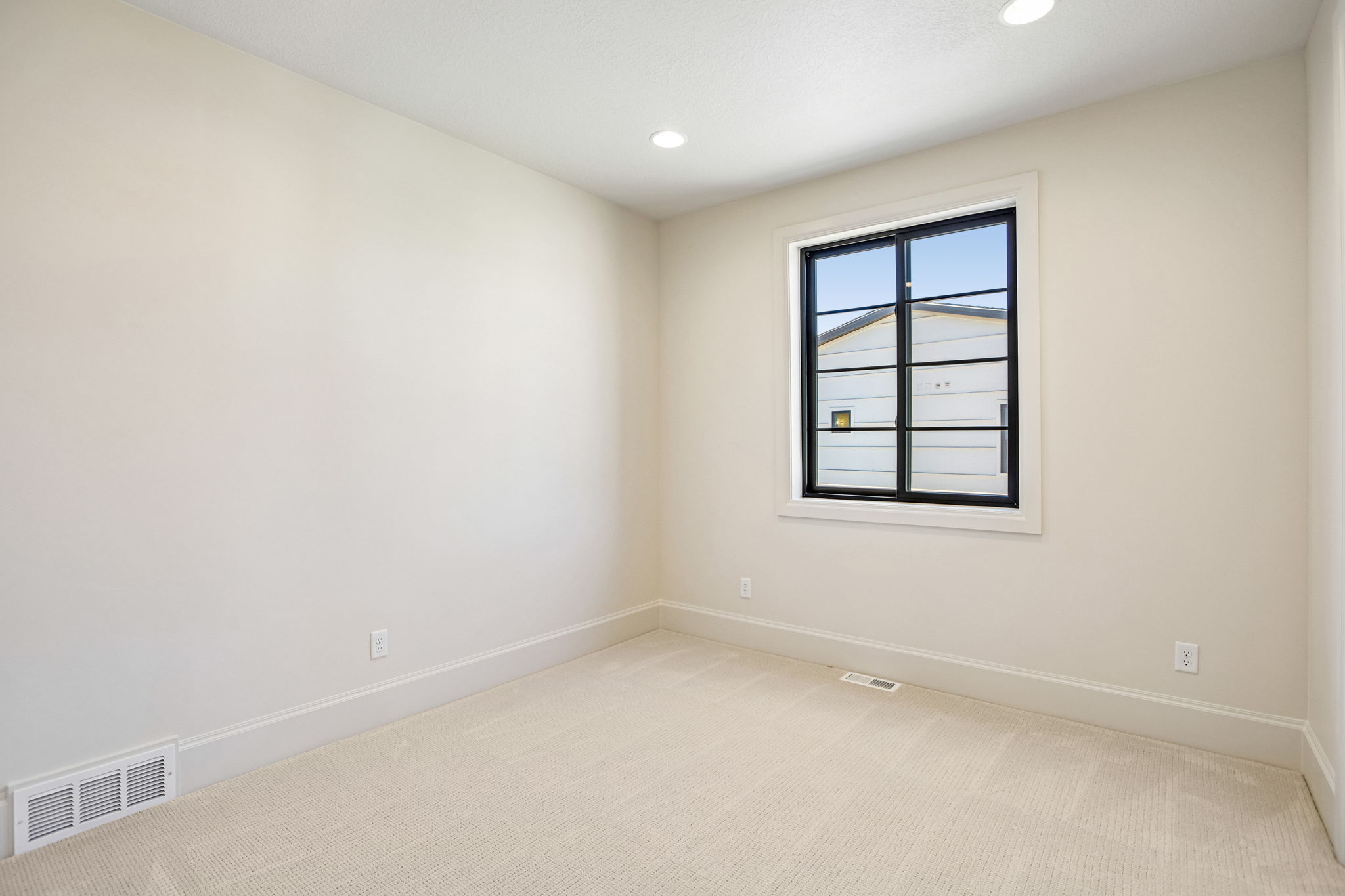 Neutral tone walls with white trim and carpeting
