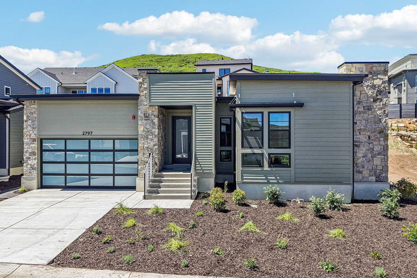 Modern exterior with horizontal siding and stone accents