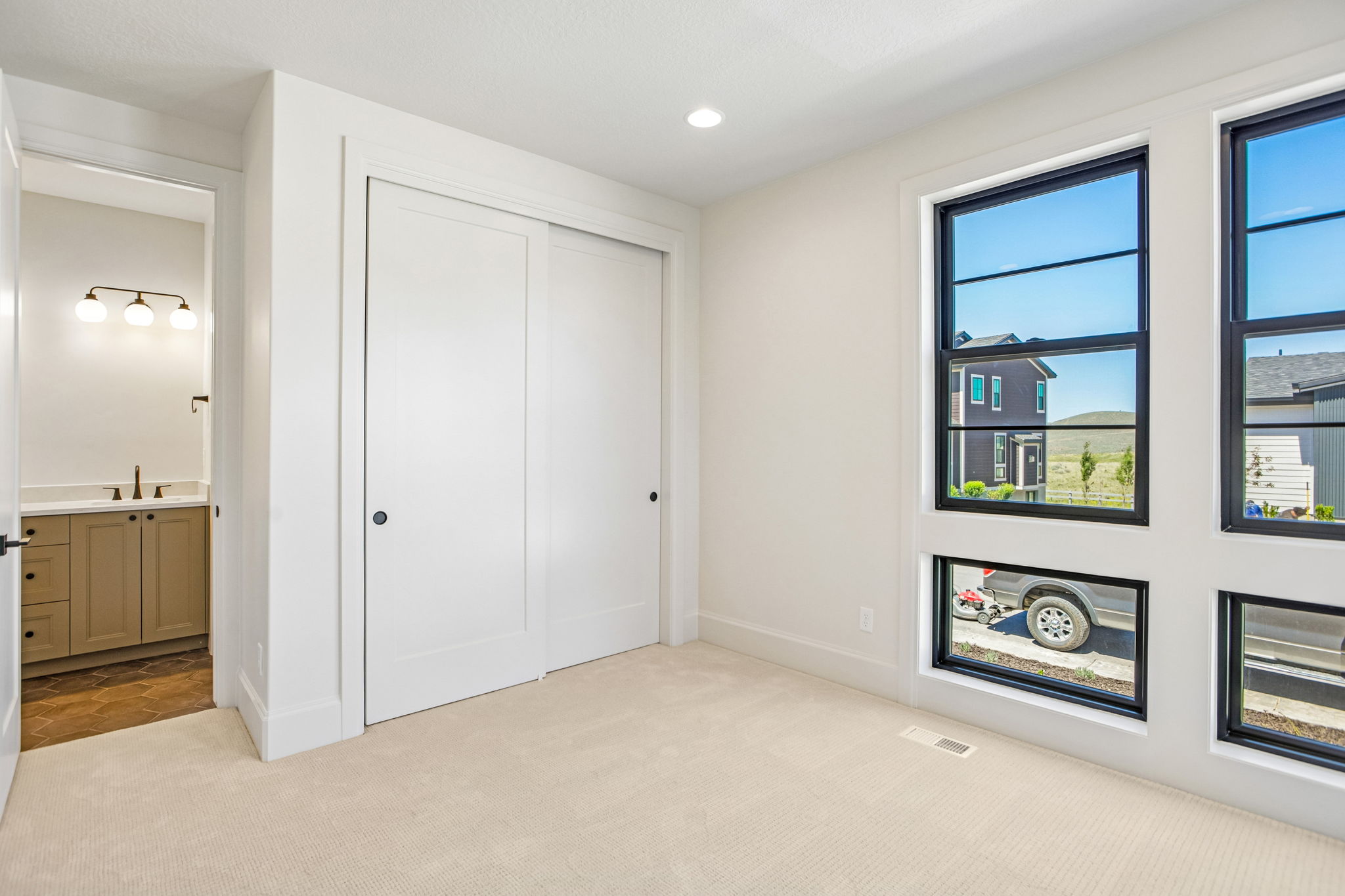 Room featuring light-colored carpet flooring and white walls