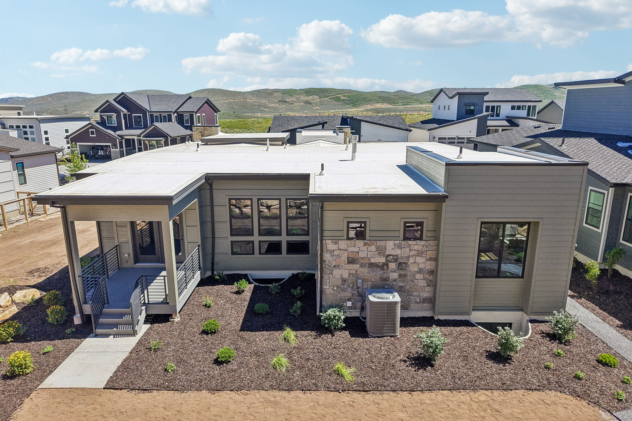 Contemporary exterior featuring earth-toned siding and stone accents