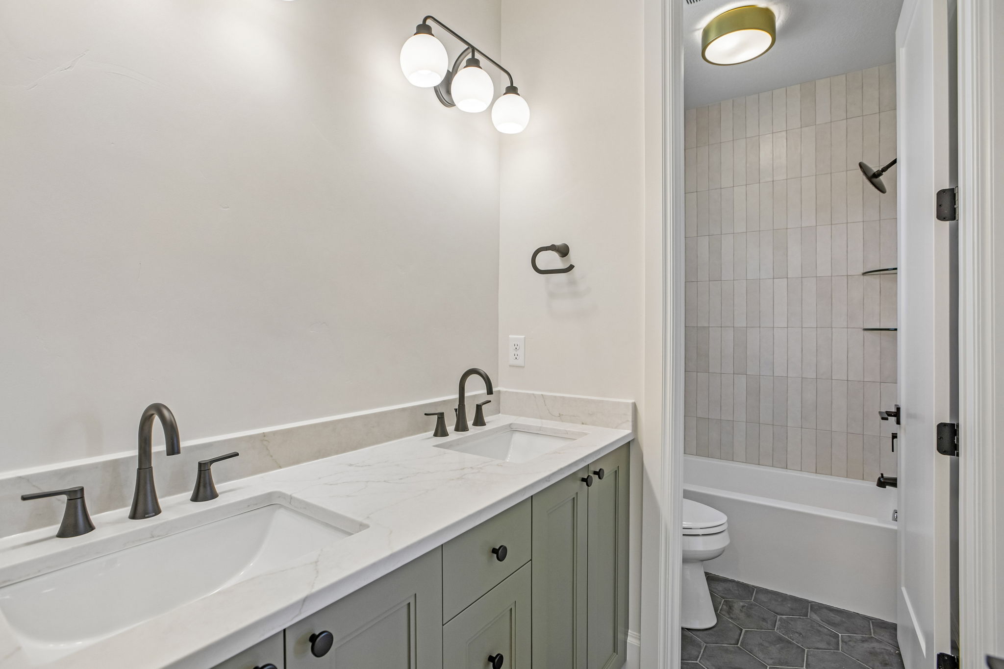 Dual vanity with matte black fixtures and white countertop