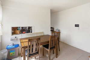 Dining area featuring neutral wall tones and tile flooring