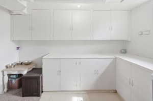 White cabinetry offering extensive storage