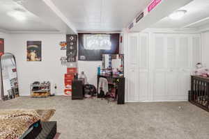 Spacious room featuring light gray carpet flooring and white walls