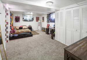 Spacious room featuring neutral carpeting and white walls