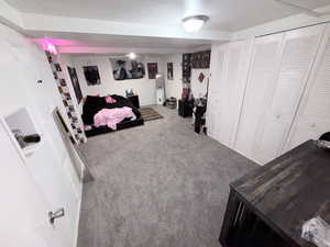 Carpeted bedroom featuring a closet