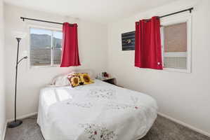 Bright room featuring two windows with white frames, providing natural light