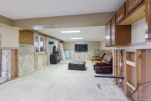 Living room with a wood stove and concrete floors