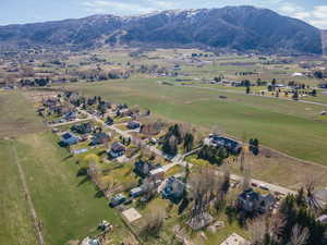 Aerial view of property and surrounding area with mountains and rural landscape