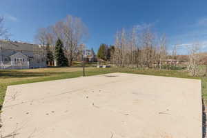View of basketball court featuring community basketball court and a yard
