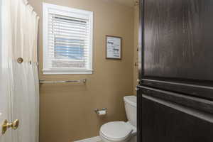 Bathroom featuring toilet and baseboards